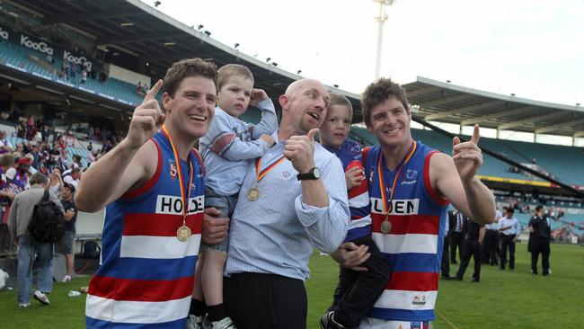 Roy Laird with his children and the Gowans’ twins, Chris and James, after Central District beat Norwood in the 2010 SANFL grand final.