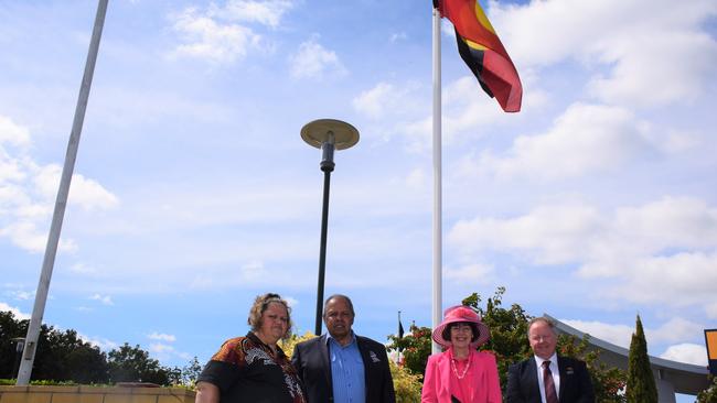 Cherbourg Mayor Elvie Sandow, Uncle Eric Law, Councillor Kathy Duff and South Burnett Mayor Brett Otto under the Aboriginal flag at the Murgon RSL. (Picture: Tristan Evert)