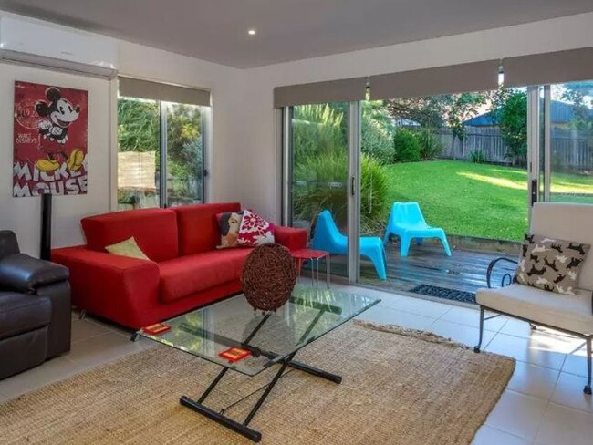 The downstairs home theatre and the massive yard out the back. Picture: Booking.com