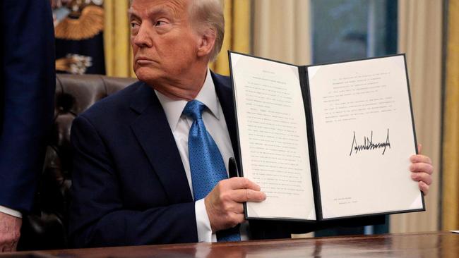 U.S. President Donald Trump holds an executive order, "Unleashing prosperity through deregulation," that he signed in the Oval Office on January 31. Picture: Chip Somodevilla/Getty Images/AFP