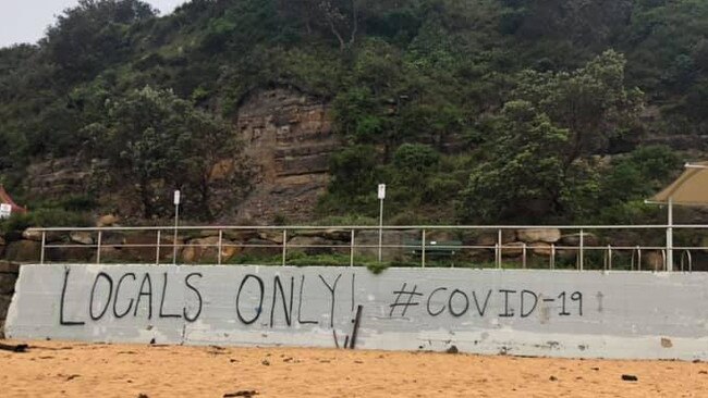 Graffiti painted on a wall close to the famous North Narrabeen surf break, allegedly by local surfers trying to keep people who don't live in the postcode of 2101 off "their beach". Picture: Facebook