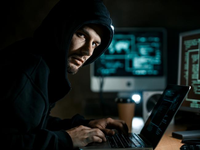 Hacker working on computer. Cyber crime concept. Scam, scammer generic.