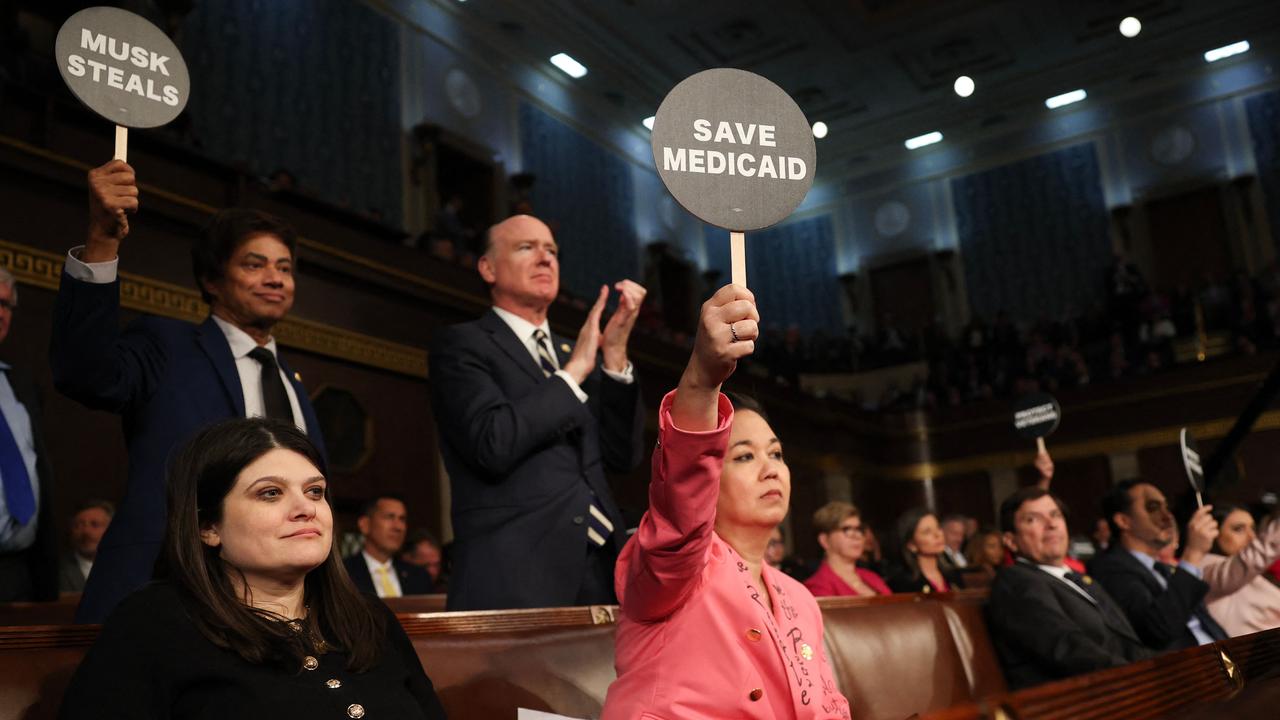 Jill Tokuda holds a protest sign with fellow Democrats as Mr Trump addresses a joint session of Congress. Picture: Win McNamee/Getty Images/AFP