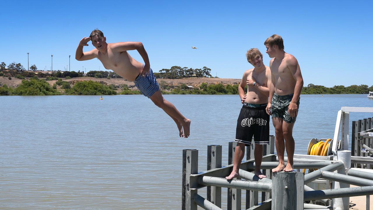 Tyson Naismith, 16, Ollie Bartlett,16, and Cooper Wilson,16, keeping cool in the river. Picture: Dean Martin