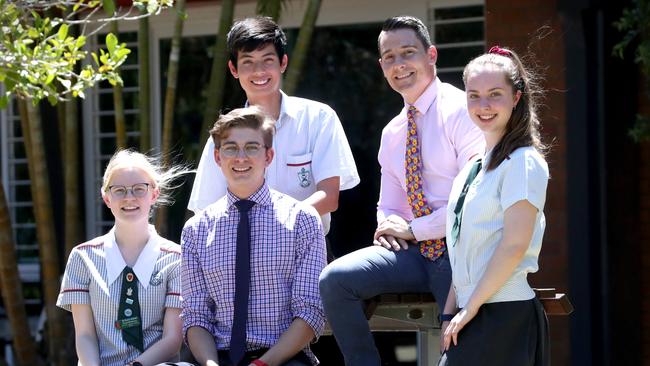 St Paul's School Bald Hills second-year teachers Chris Holley and Nathan Woods with students (from left) Gracielle Manderson, Marcus Weller and Jessica Gentle. They have bucked the trend as the number of male teachers in Queensland declines. Picture: Jamie Hanson