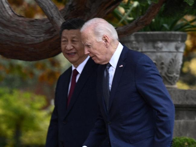 US President Joe Biden walks with Chinese President Xi Jinping as they meet at Filoli Estate during the Asia-Pacific Economic Cooperation (APEC) Leaders' week in Woodside, California, on November 15, 2023. Biden and Xi will try to prevent the superpowers' rivalry spilling into conflict when they meet for the first time in a year at a high-stakes summit in San Francisco on Wednesday. With tensions soaring over issues including Taiwan, sanctions and trade, the leaders of the world's largest economies are expected to hold at least three hours of talks at the Filoli country estate on the city's outskirts. (Photo by Brendan SMIALOWSKI / AFP) / ALTERNATIVE CROP