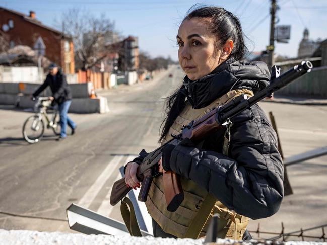 A volunteer takes position at a checkpoint in a district in Kyiv. Picture: AFP