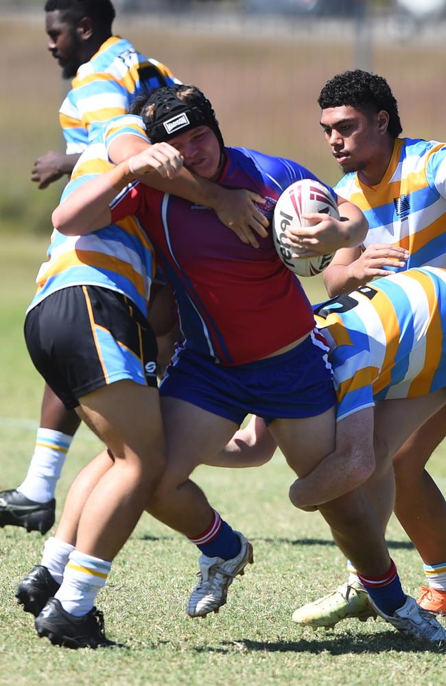 Boys Rugby League State Championship held at Northern Division, Brothers Leagues ground, Townsville. 16-18 years. Peninsula (stripe) v Darling Downs (blue/purple). Thomas Fenwick of Toowoomba Grammar School.