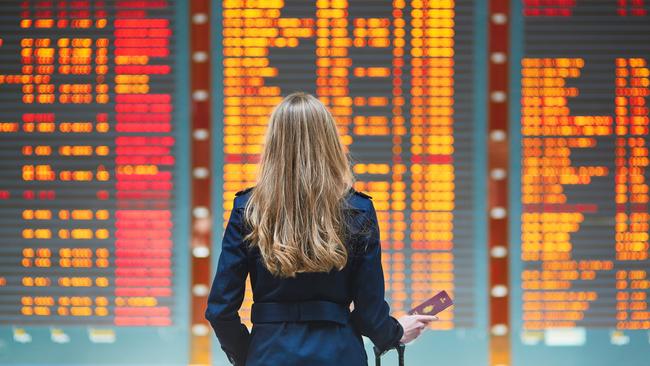 Woman looking at the flight information board.