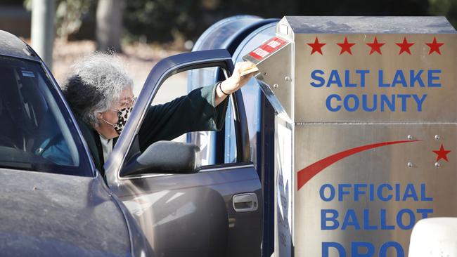 A voter drops off her mail-in ballot at a dropbox at the Salt Lake County election office in Salt Lake City, Utah. Picture: AFP