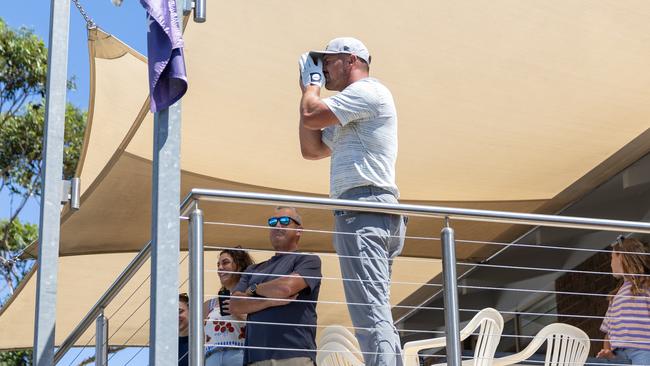 Captain Bryson DeChambeau of Crushers GC reads yardage from a balcony on the 13th hole  during the second round of LIV Golf Adelaide at Grange Golf Club on Saturday, February 15, 2025 in Adelaide, Australia. (Photo by Jon Ferrey/LIV Golf)