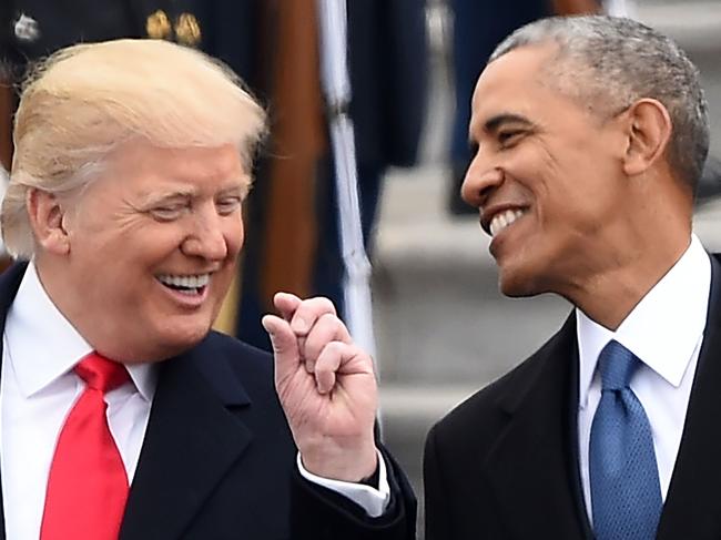 US President Donald Trump and former President Barack Obama talk on the East steps of the US Capitol after inauguration ceremonies on January 20, 2017, in Washington, DC.  / AFP PHOTO / Robyn BECK