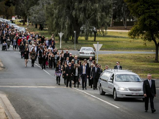 Family and friends line a street in Loxton, South Australia, to lay her to rest. Picture: Mike Burton