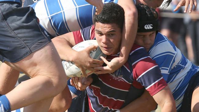 TSS Player Noah Lolesio is tackled by Nudgee. Picture Mike Batterham