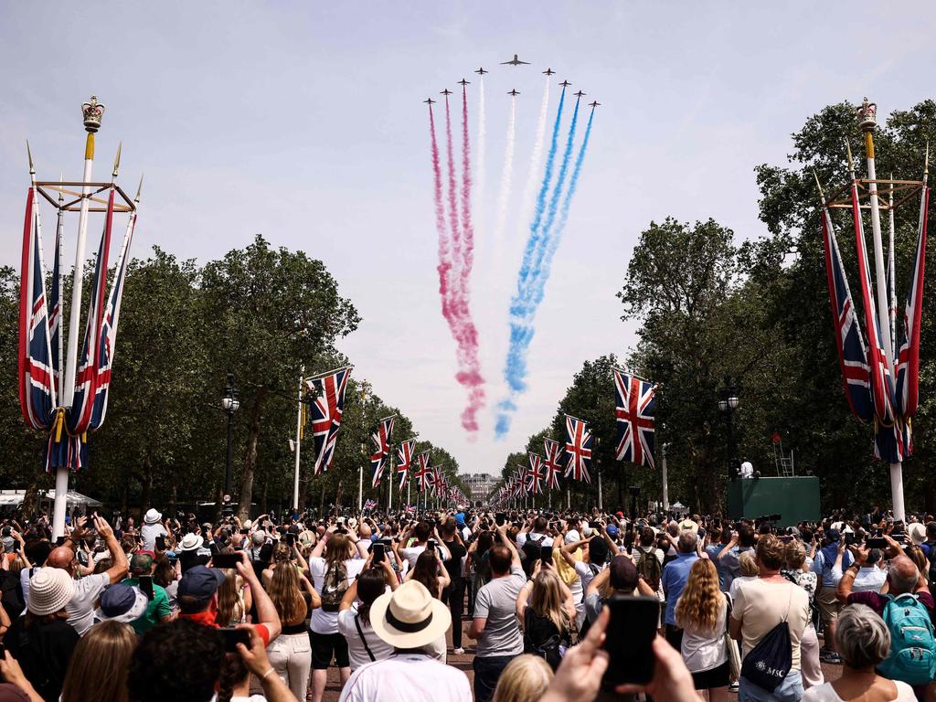 Members of the public cheer as they watch the Royal Air Force Aerobatic Team, the Red Arrows during the King's Birthday Parade. Picture: HENRY NICHOLLS / AFP