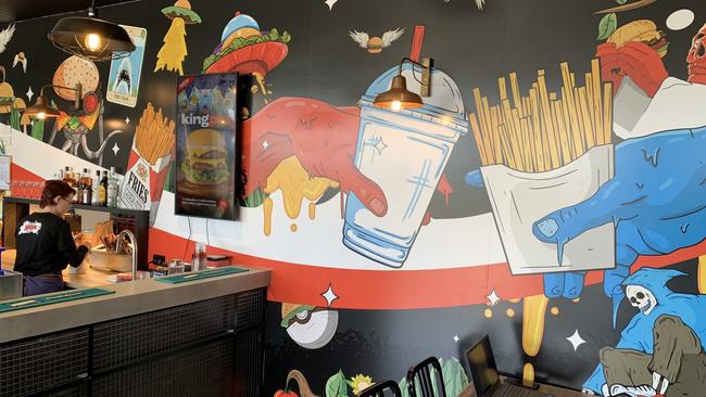 The new Burger Urge in Andergrove features murals by artist Andy Pineapples. Picture: Duncan Evans
