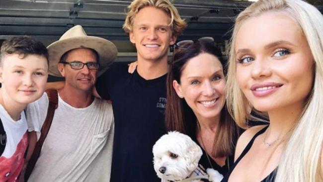 With her family: from left, brother Tom, father Brad, Cody, mother Angie and dog Buddy.