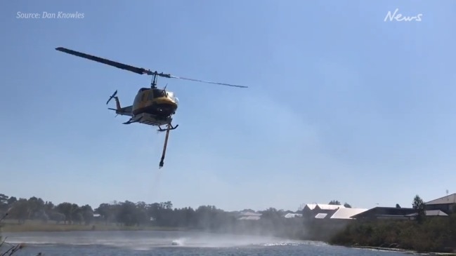 Waterbombing helicopters join the fight against the Peregian fire