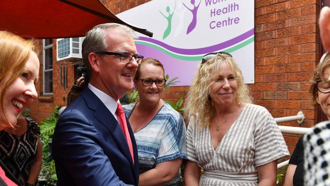 Newly appointed NSW Attorney General Michael Daley (centre) during a visit to the Women's Health Centre. (AAP Image/Dean Lewins)