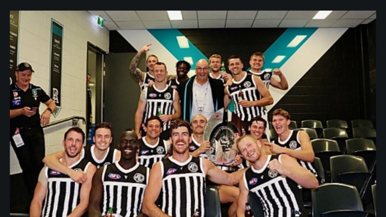 David Koch with Port Adelaide players, wearing the prison bar guernseys. Picture: David Koch/Twitter.