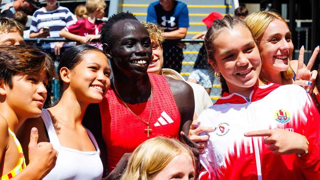 Australian sprinter Gout Gout poses for photographs with fans.