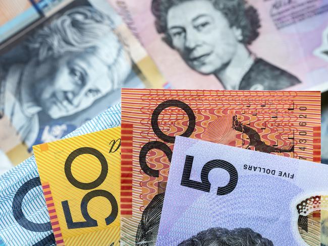 Australian money background.  Focus on foreground, blurred faces beneath. Notes generic