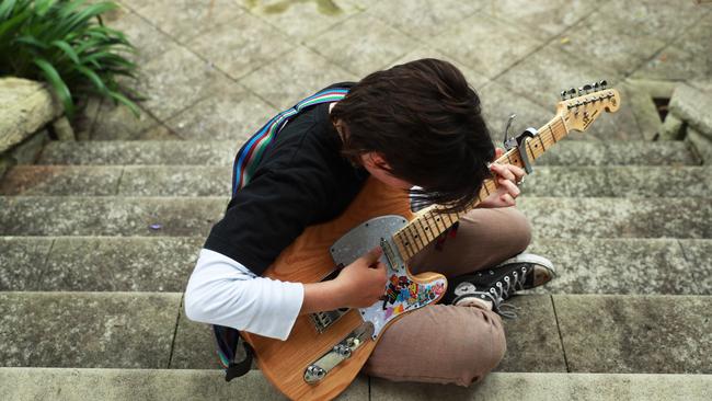 Will plays guitar at his Sydney home. Picture: John Feder