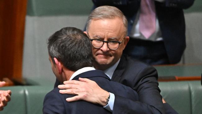 Prime Minister Anthony Albanese hugs Treasurer Jim Chalmers after he delivered the Albanese government's first budget in the House of Representatives.