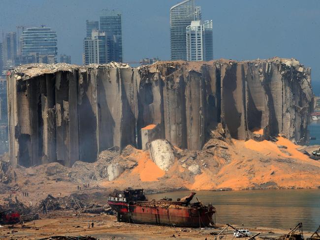 This photo shows a damaged grain silo and a burnt boat at Beirut’s harbour. Picture: AFP