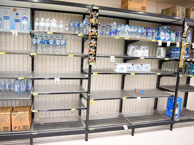 Near empty supermarket shelves are seen as Townsville residents prepare for Cyclone Debbie. Picture: Ian Hitchcock/Getty Images