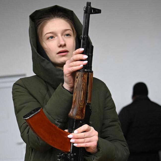 A young woman learns how to use an AK-47 assault rifle on the outskirts of Lviv, western Ukraine, last week. Picture: AFP