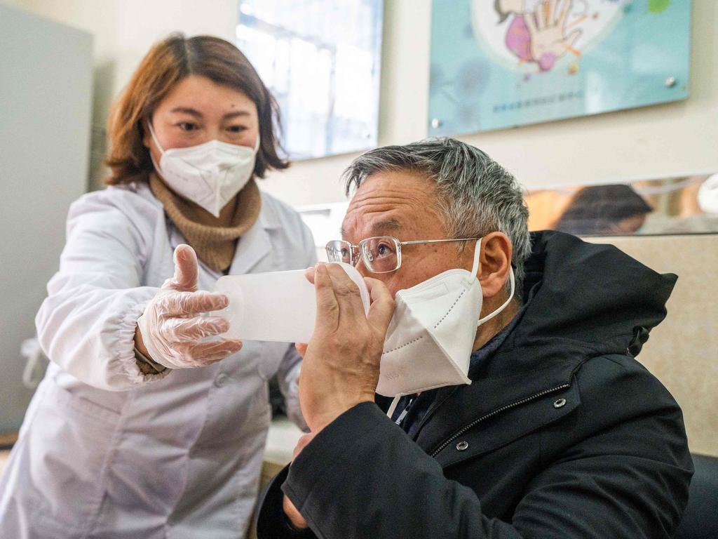 A health worker administering a dose of CanSino Biologics inhalable Covid-19 coronavirus vaccine in Bijie, in China's southwestern Guizhou province. Picture: AFP