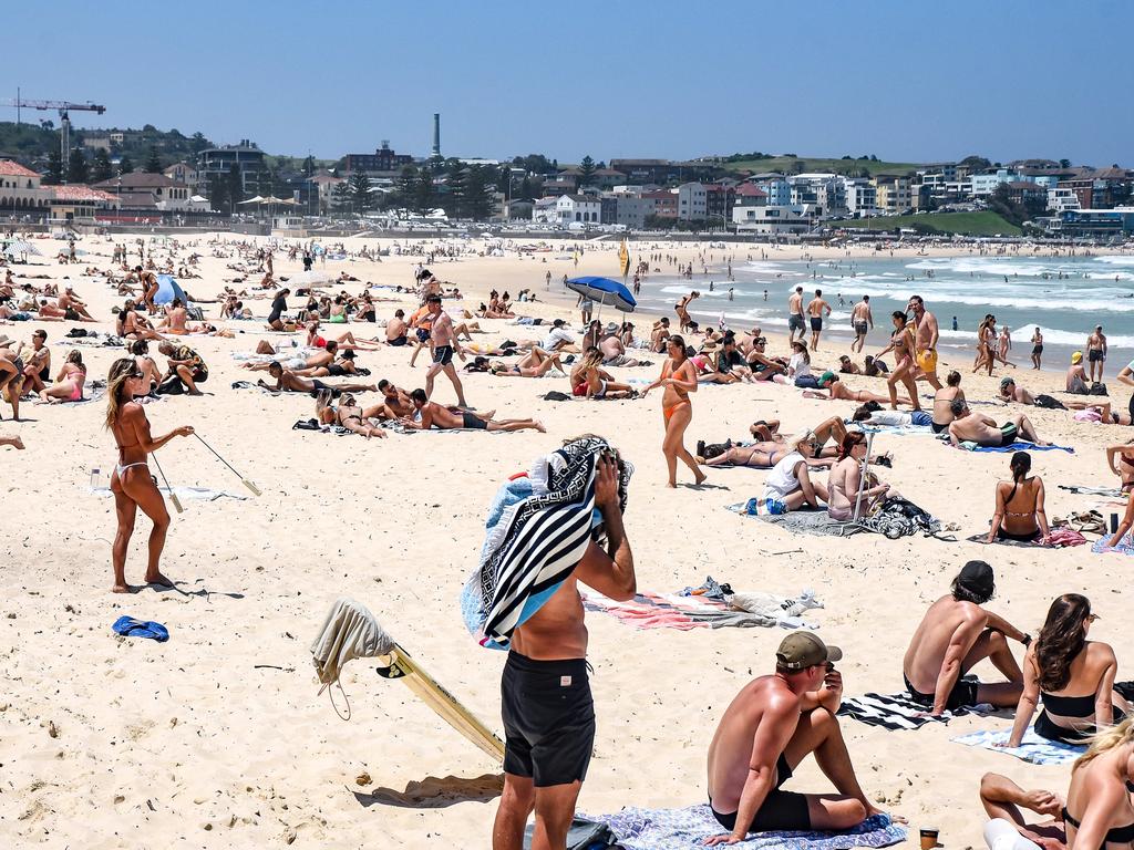 People are seen at Bondi Beach on a hot day despite the marine warning of a Tsunami. Picture: NCA NewsWire / Flavio Brancaleone