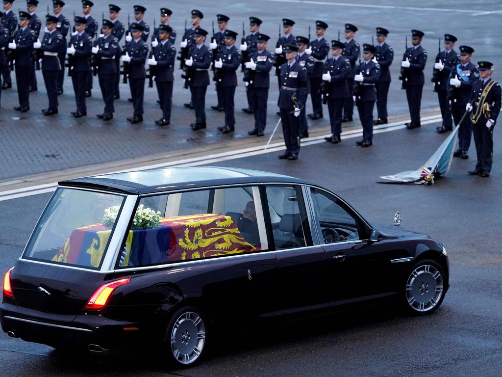 The Queen’s Colour Squadron, RAF, stand by as the coffin of Queen Elizabeth II is taken away in the Royal Hearse from the Royal Air Force Northolt air base on September 13 to travel to Buckingham Palace. Picture: Andrew Matthews / AFP