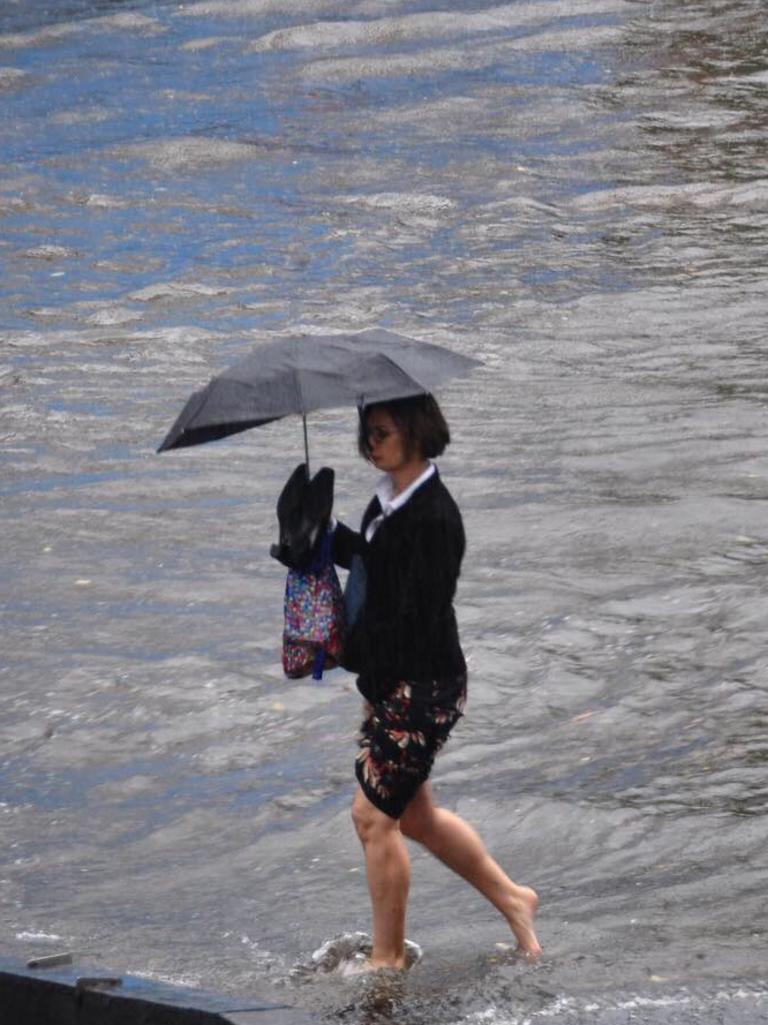 A woman braves floodwater on Commercial Rd. Picture: Alexandra Owen