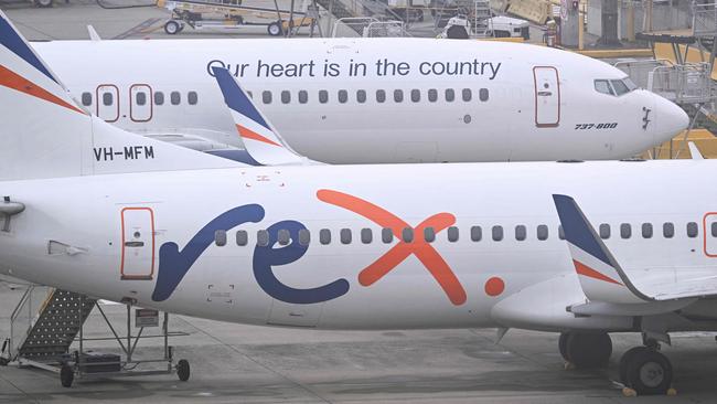 Rex Airlines Boeing 737 planes lay idle on the tarmac at Melbourne's Tullamarine Airport on July 31, 2024. The Australian regional airline Rex cancelled flights as it entered voluntary administration on July 31, leaving the fate of the country's third-largest carrier in serious doubt. (Photo by William WEST / AFP)