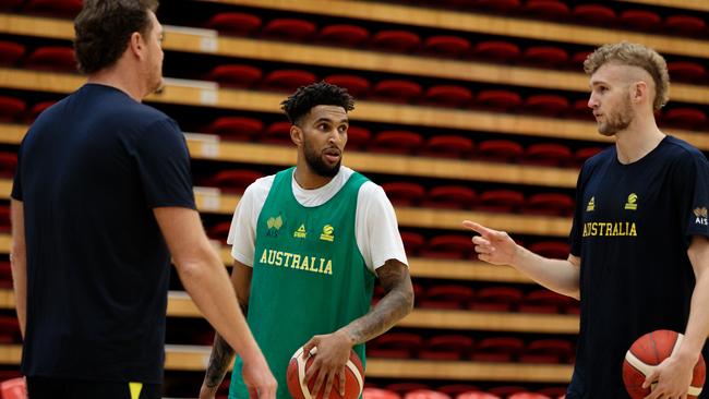 Jonah Bolden (centre) and Jock Landale (right) talk with Boomers assistant coach Luc Longley during a training session in Perth. Picture: AAP/Richard Wainwright