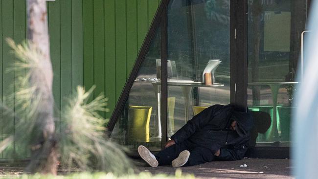 A man is slumped outside the injecting room site at North Richmond. Picture: Jason Edwards