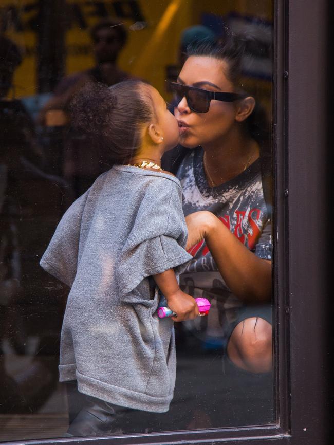 Tender moment ... North West gives her mum a kiss. Picture: Splash