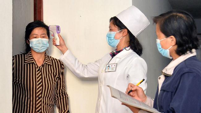 This picture taken on May 17, 2022 and released from North Korea's official Korean Central News Agency (KCNA) on May 18 shows residents being checked to prevent the spread of the Covid-19 coronavirus in Pyongyang. (Photo by KCNA VIA KNS / AFP) / - South Korea OUT / ---EDITORS NOTE--- RESTRICTED TO EDITORIAL USE - MANDATORY CREDIT "AFP PHOTO/KCNA VIA KNS" - NO MARKETING NO ADVERTISING CAMPAIGNS - DISTRIBUTED AS A SERVICE TO CLIENTS THIS PICTURE WAS MADE AVAILABLE BY A THIRD PARTY. AFP CAN NOT INDEPENDENTLY VERIFY THE AUTHENTICITY, LOCATION, DATE AND CONTENT OF THIS IMAGE. /