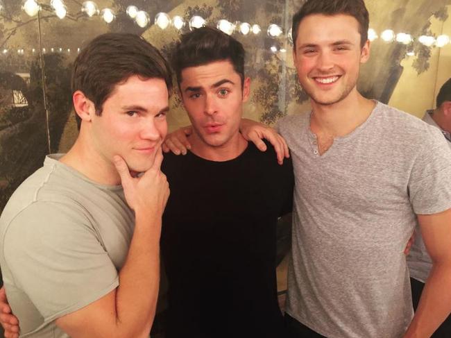 Zac Efron poses with his brother Dyland and costar Adam Devine, 