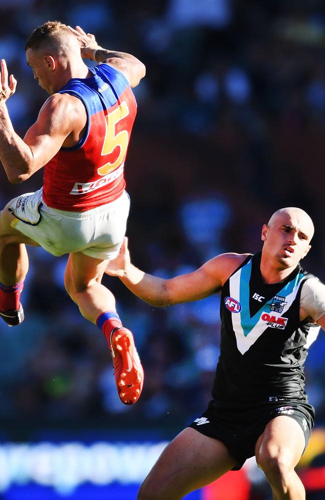 Mitch Robinson flies over Sam Powell-Pepper at Adelaide Oval on Saturday. Picture: Mark Brake/Getty Images