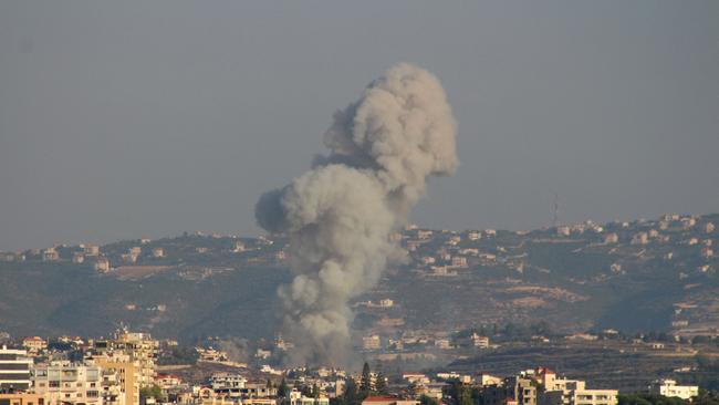 Smoke billows over the Lebanese village Abbasiyeh after an Israeli strike. Picture: Kawnat Haju/AFP