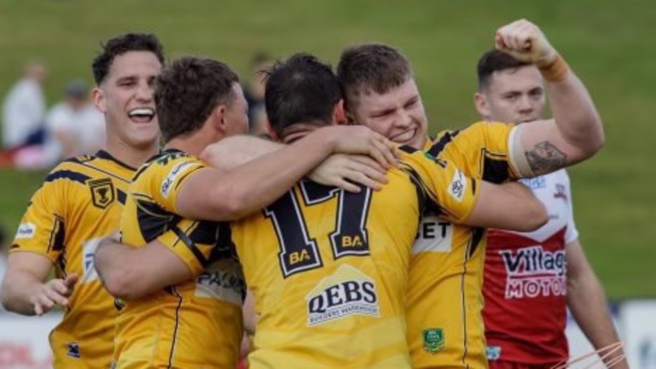 Sunshine Coast Falcons player Jack Gibbons punches the air with his teammates.