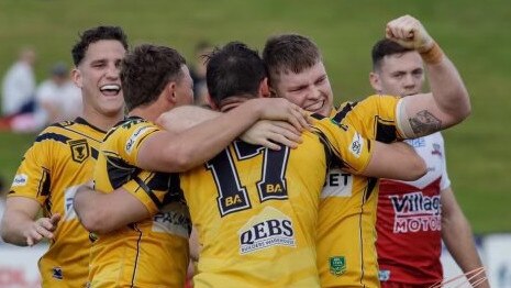 Sunshine Coast Falcons player Jack Gibbons punches the air with his teammates.