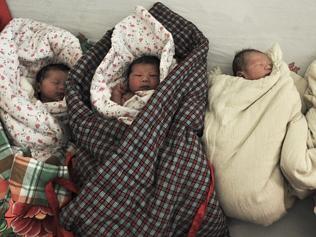 In this photo taken Wednesday, Jan. 25, 2012, newborn babies wait to be bathed at a hospital in Zouping county in east China'...