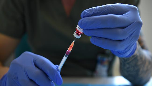 SYDNEY, AUSTRALIA - NewsWire Photos FEBRUARY, 19, 2021: A pharmacist demonstrates the filling of syringes ahead of the Covid-19 vaccine rollout at the USYD Brain and Mind Centre at Camperdown in Sydney. Picture: NCA NewsWire/Joel Carrett