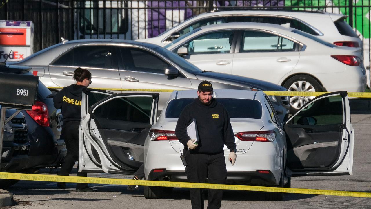 Crime scene investigators in the FedEx car park where Brandon Hole began his massacre, shooting four dead before entering the building. Picture: Jeff Dean/ AFP