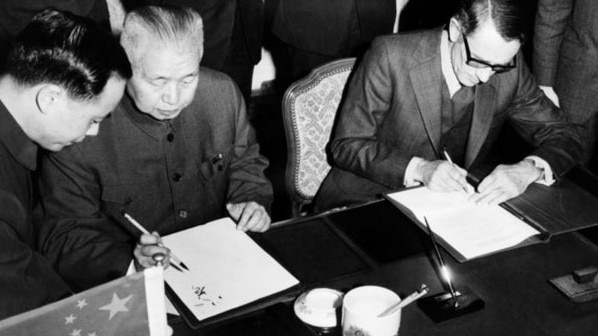 Huang Chen and Alan Renouf sign the agreement in Paris establishing diplomatic relations with China.