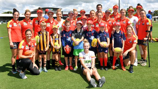 The Gold Coast Suns AFLW team with a group of juniors who participated in a training session at Harrup Park. Picture: Tony Martin